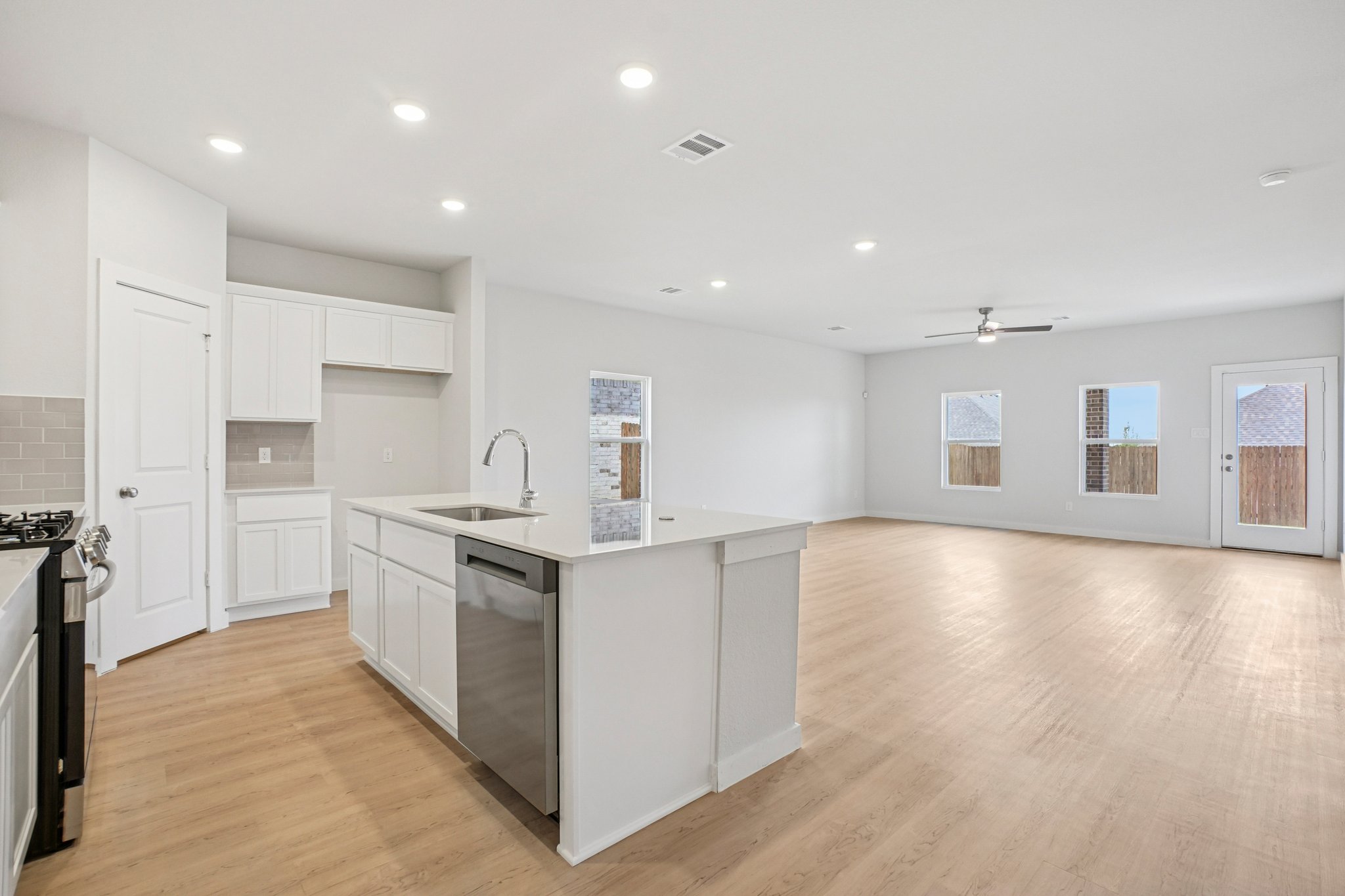 A kitchen with white cabinets.