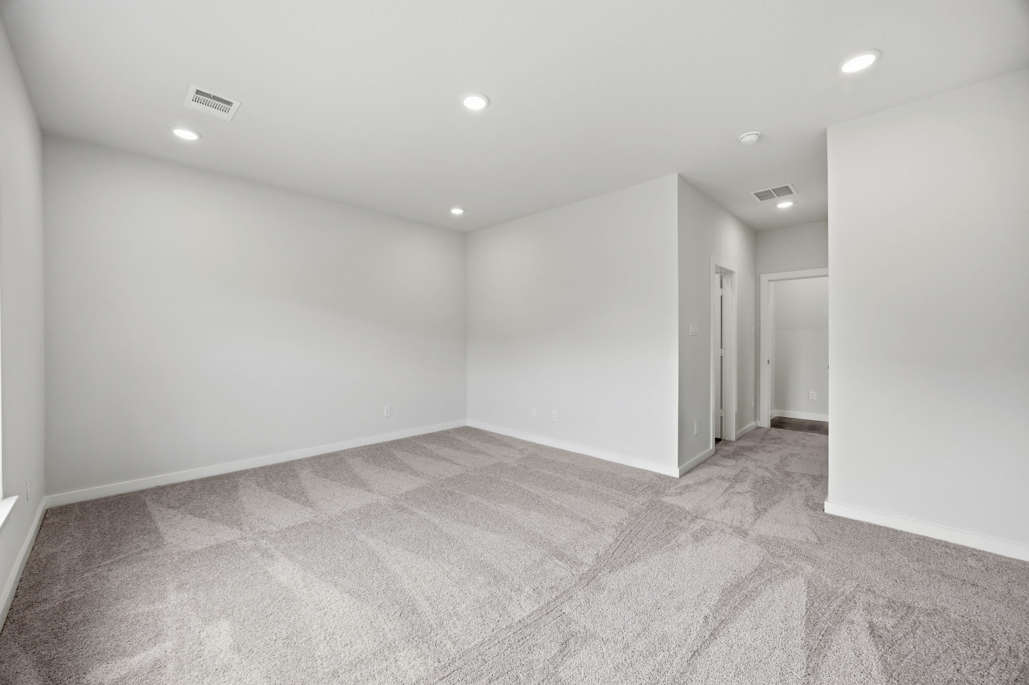A long hallway with white walls.