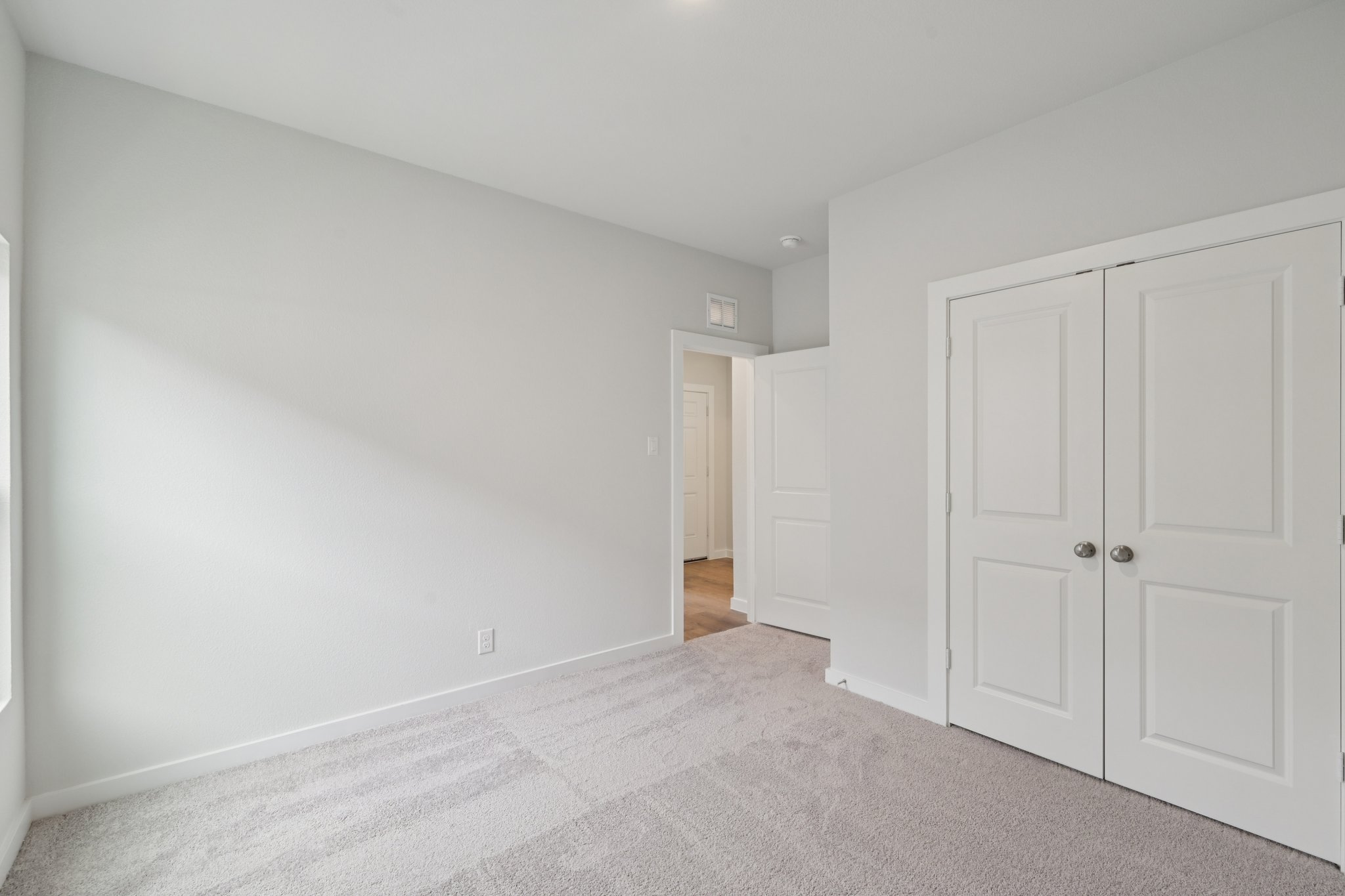 A hallway with white doors.