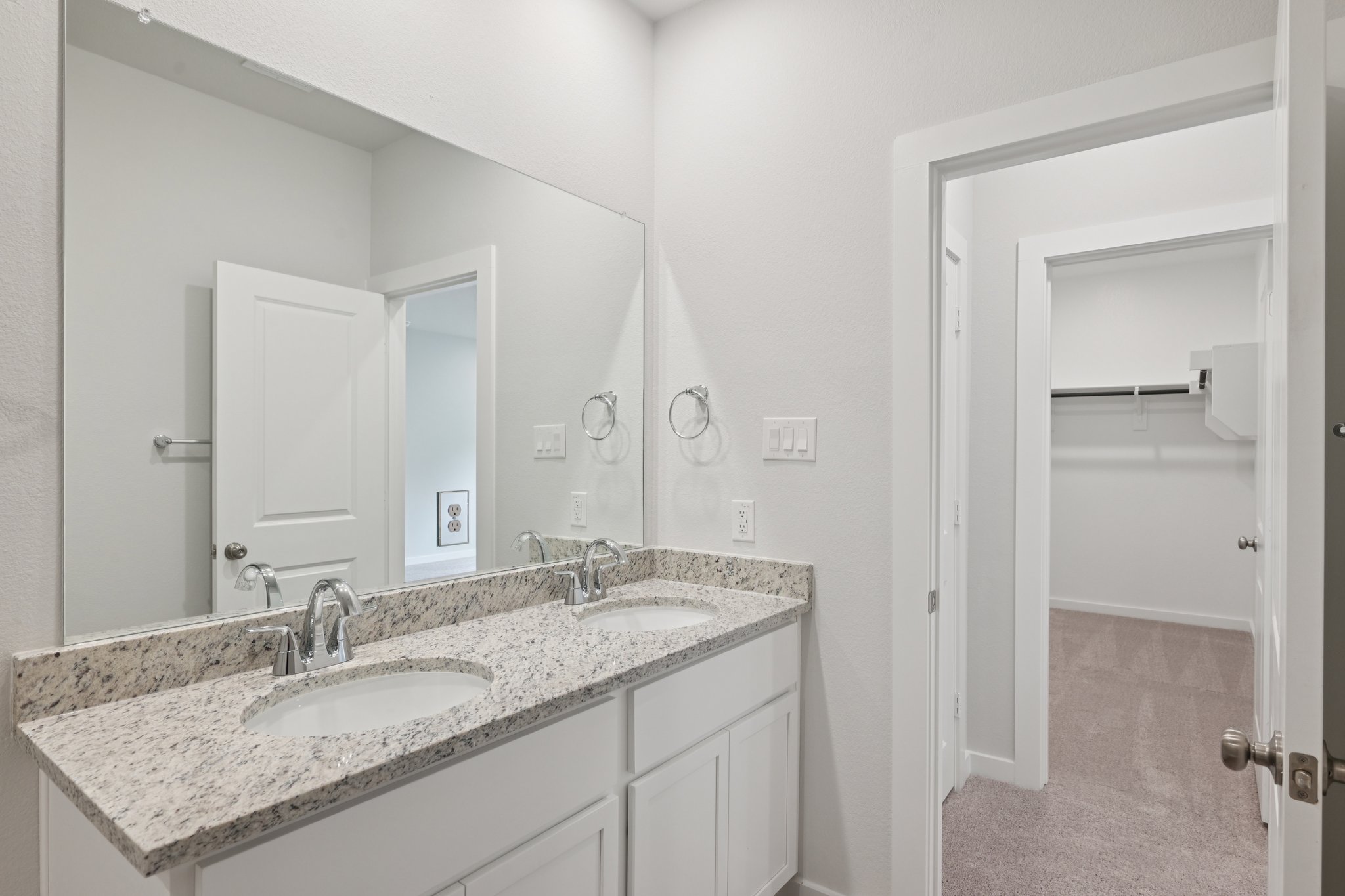 A bathroom with a marble countertop.