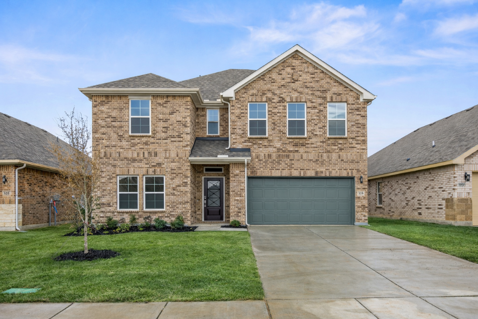 A brick building with a driveway.