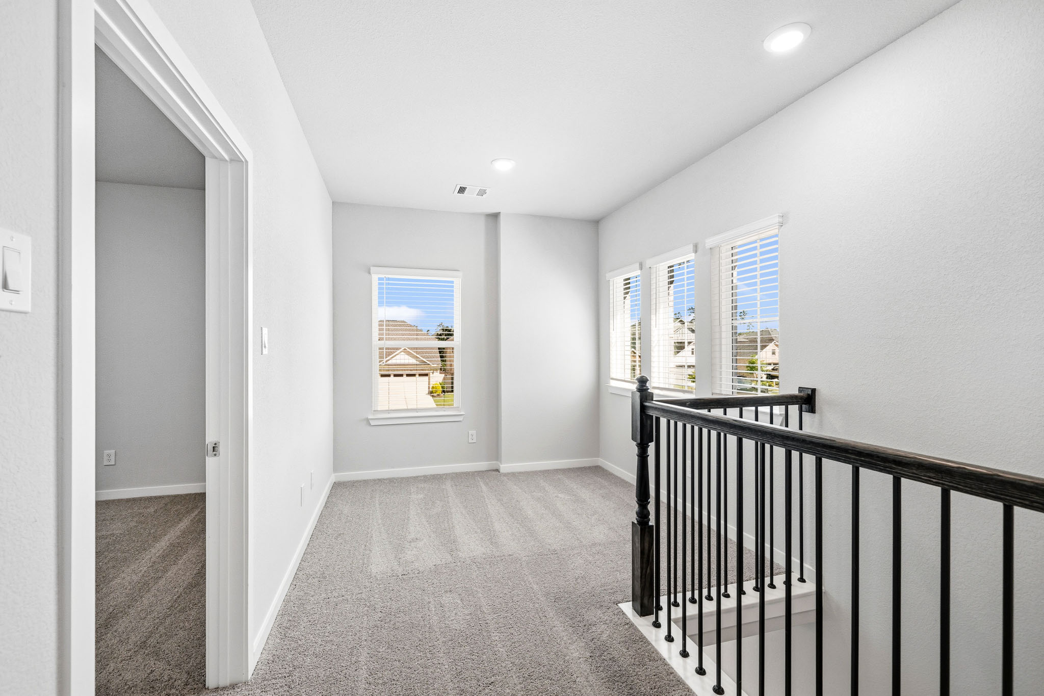A hallway with a railing.