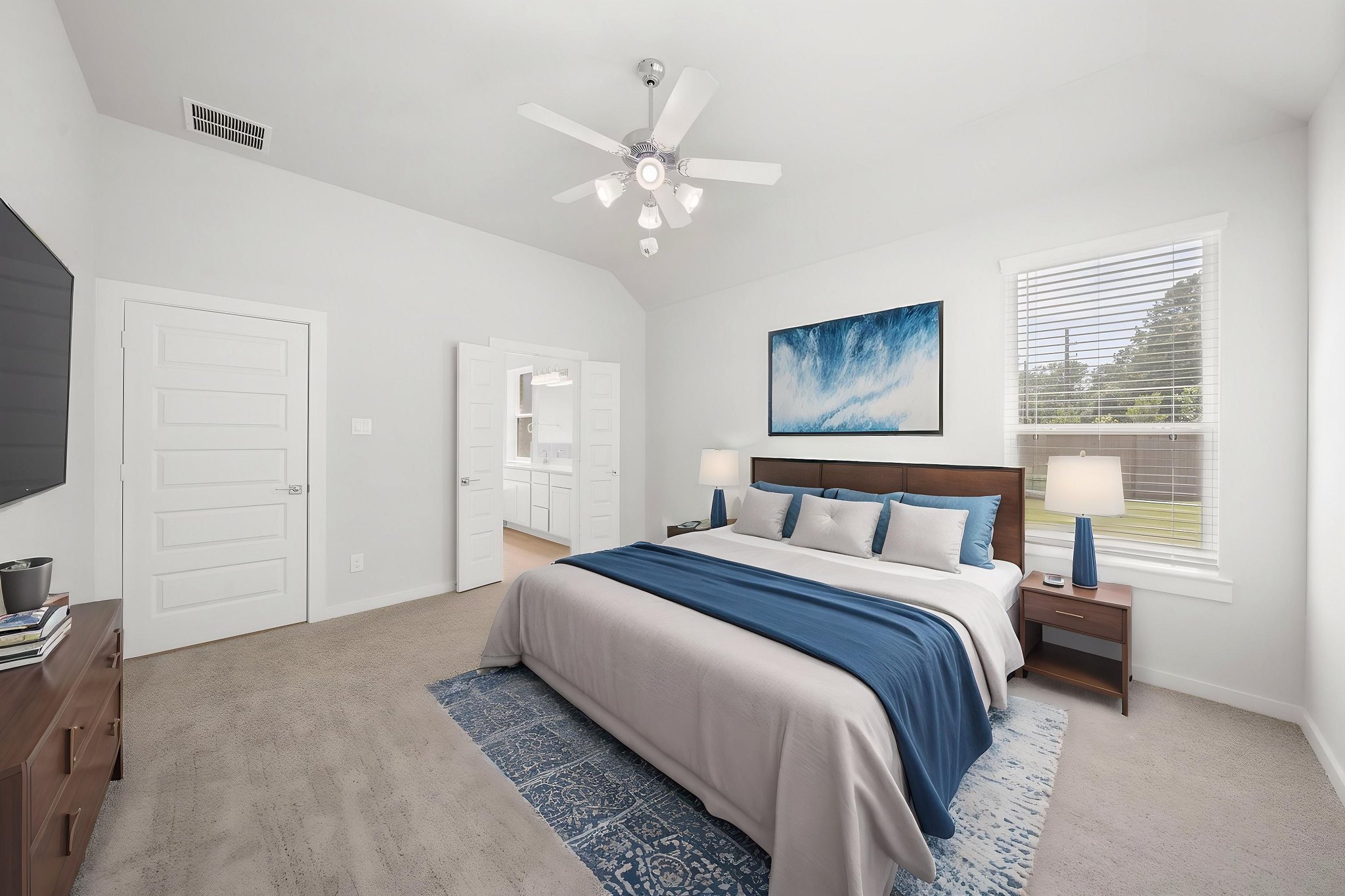A bedroom with a bed and a fan.