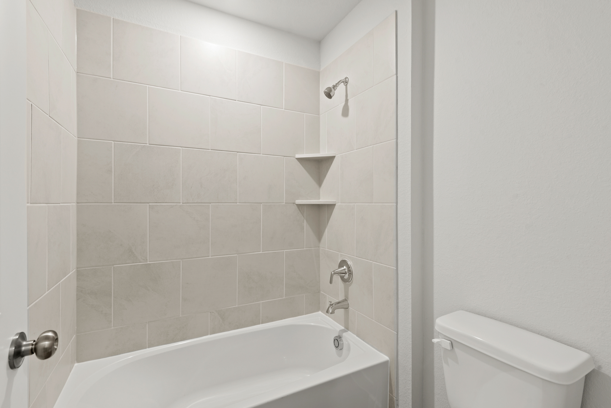 A bathroom with a tub toilet and sink.