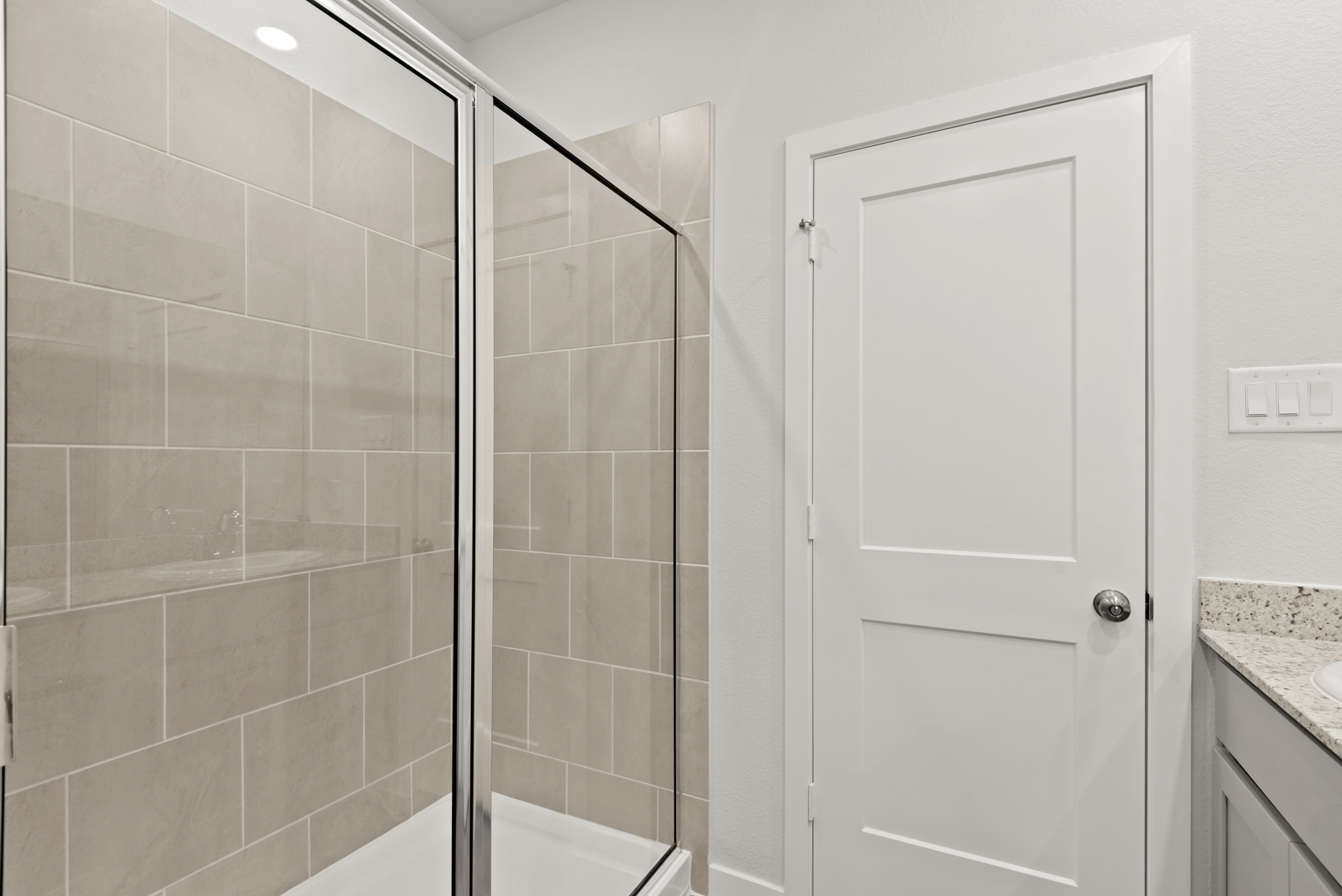A shower with a glass door.