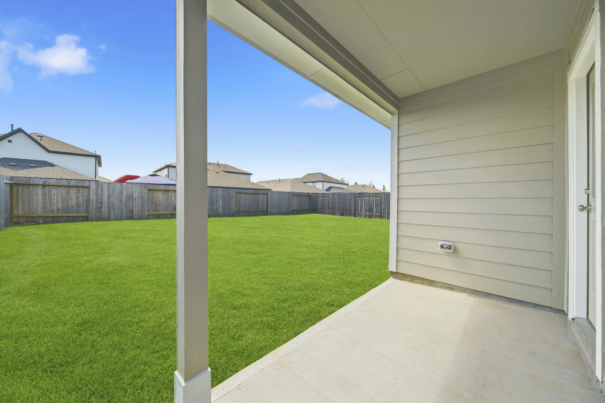 A house with a fence and grass.
