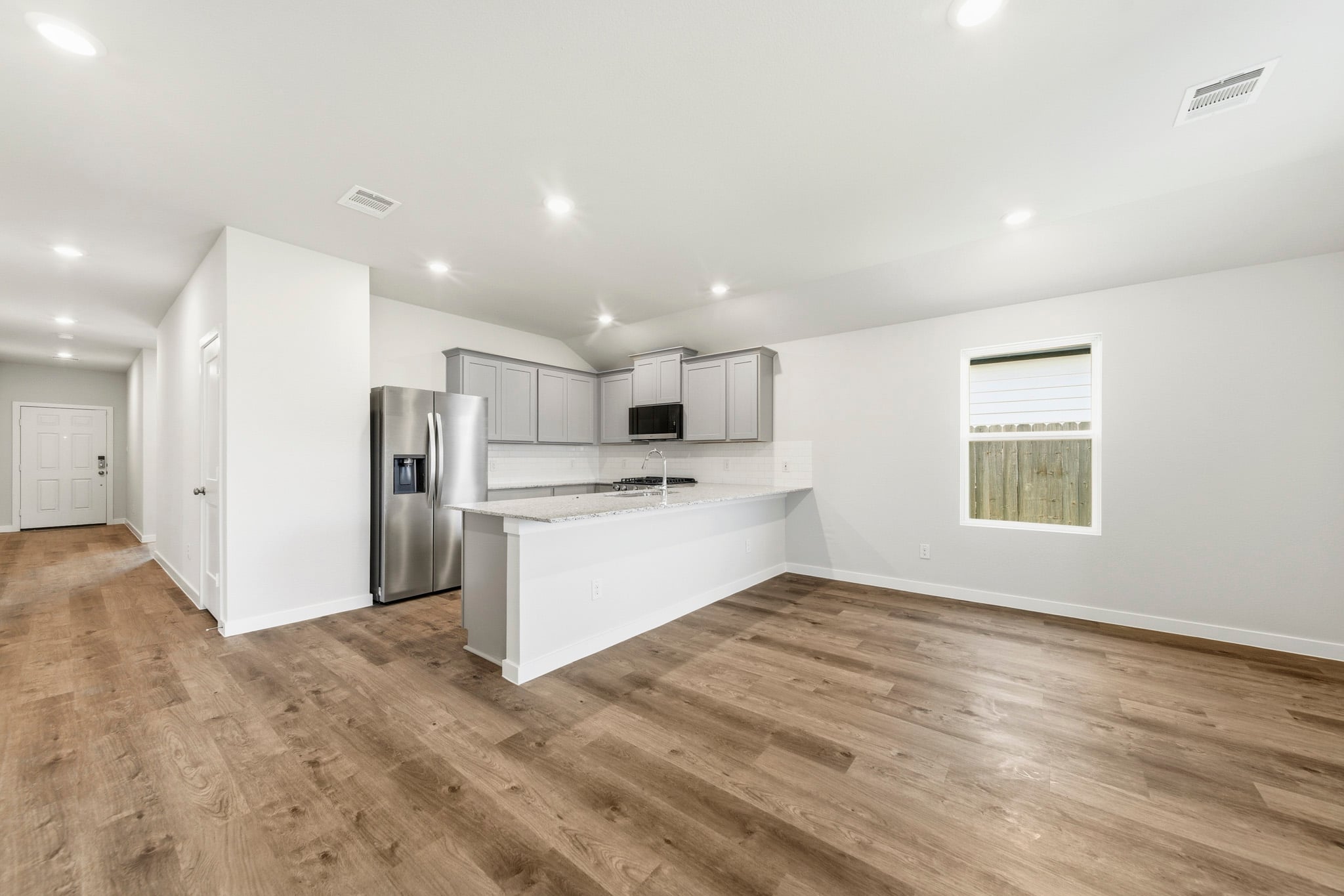 A kitchen with white cabinets.
