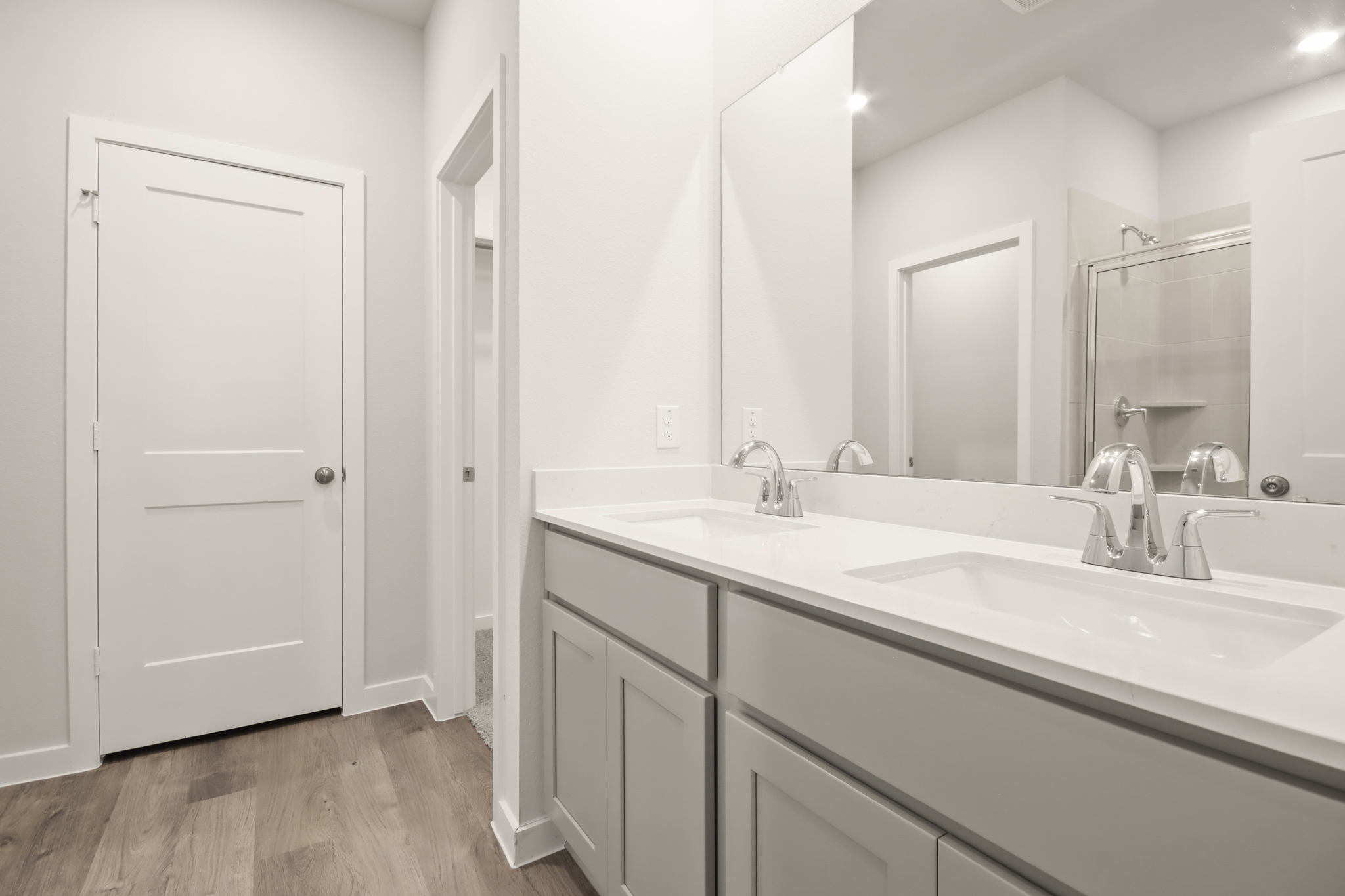 A bathroom with a large mirror.