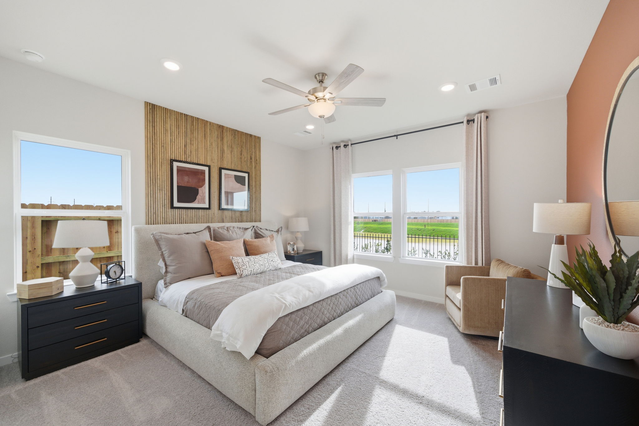A bedroom with a large window.
