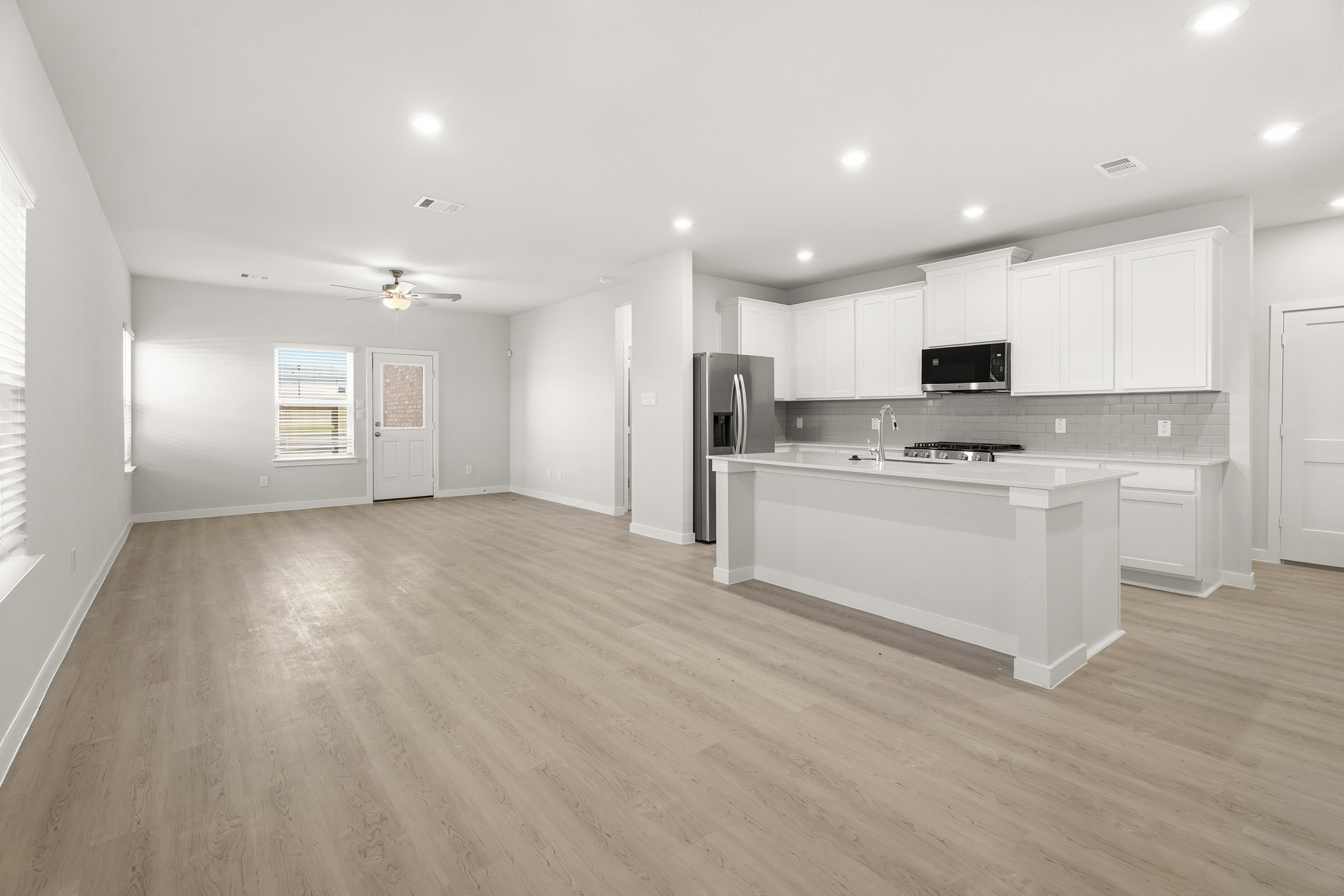 A kitchen with white cabinets.