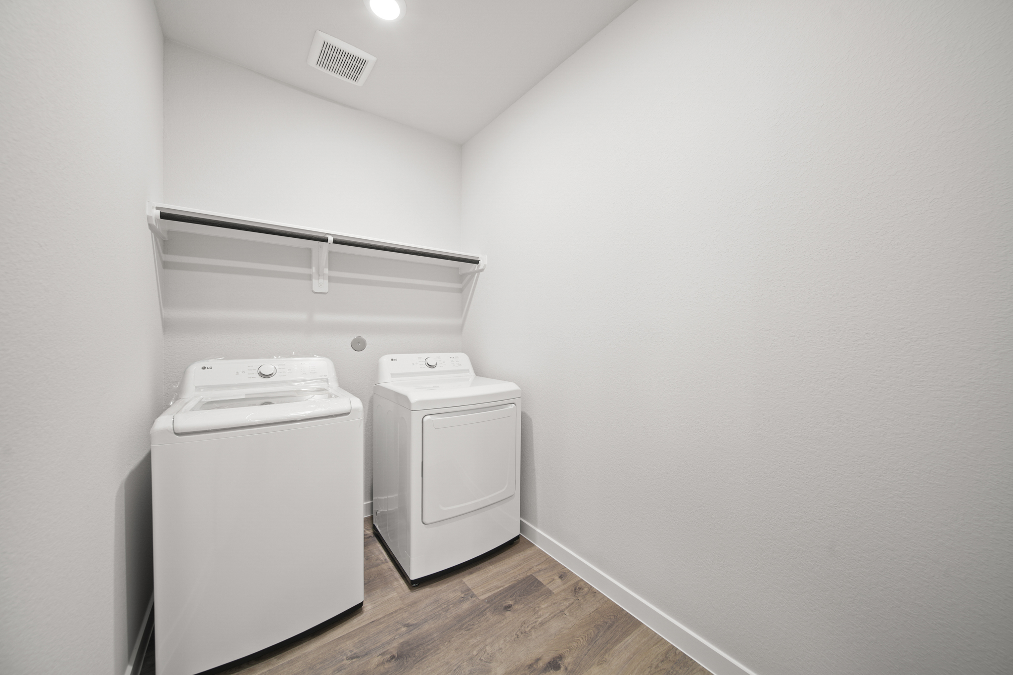 A room with a washer and dryer.