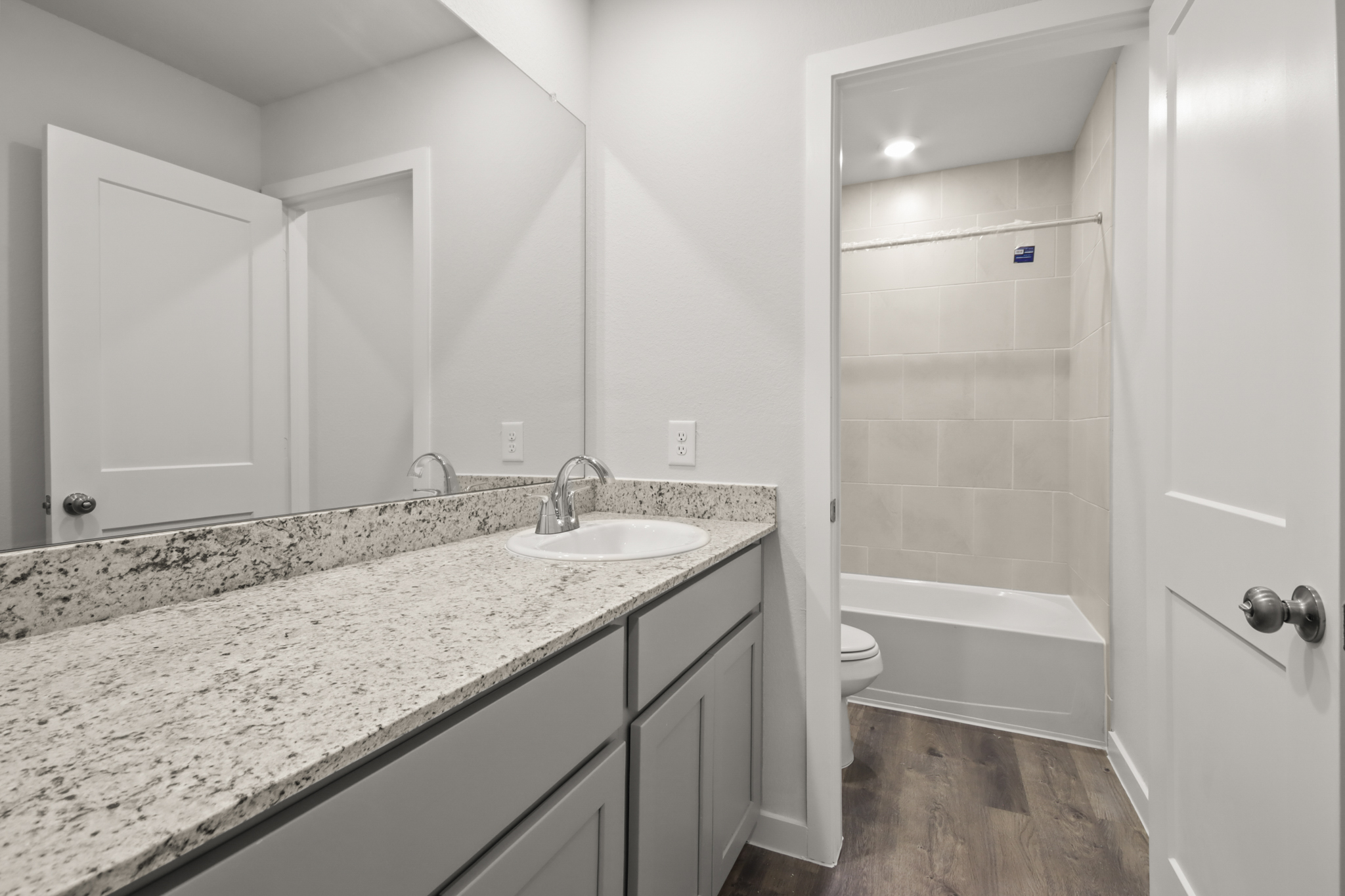 A bathroom with a marble countertop.