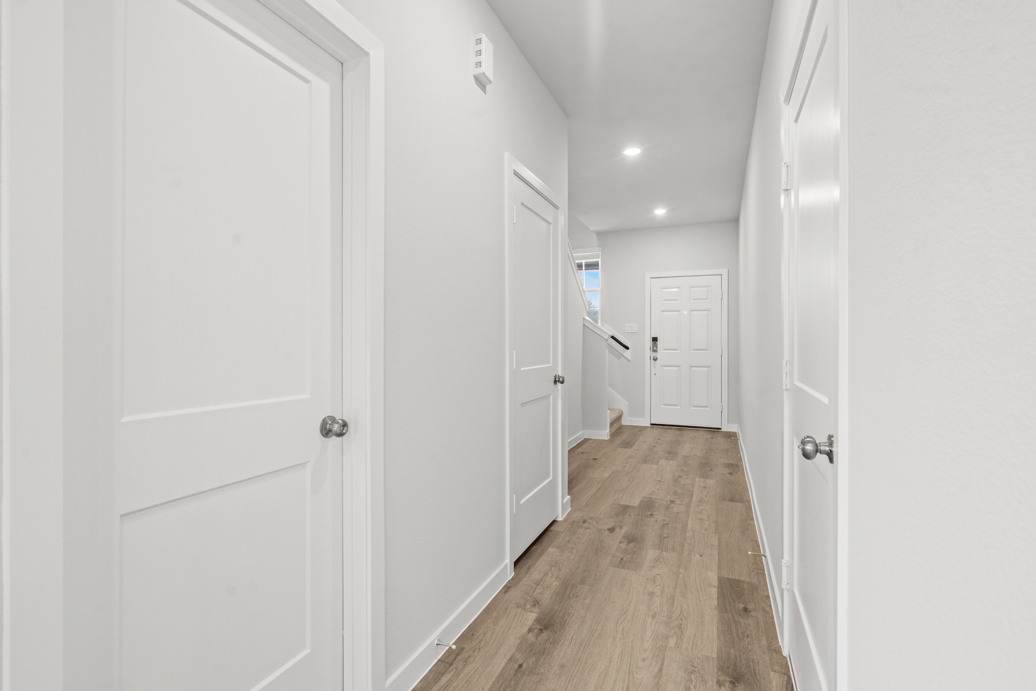 A hallway with white doors.