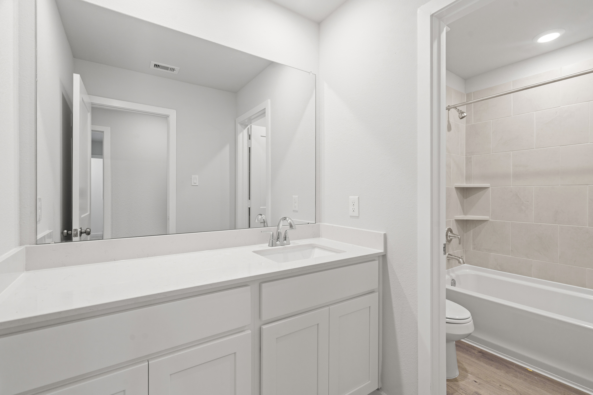 A bathroom with a tub sink and toilet.