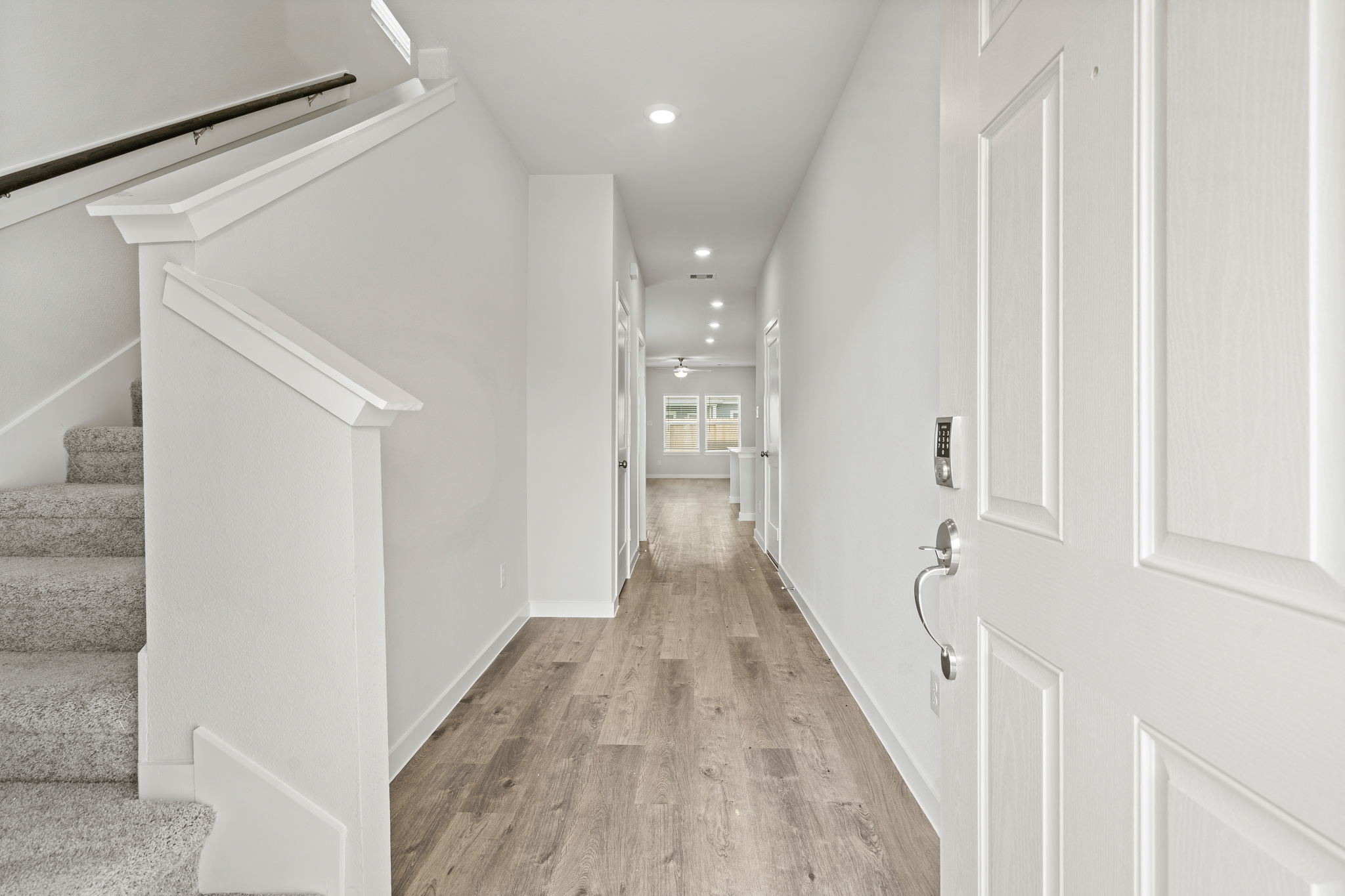 A hallway with white walls.