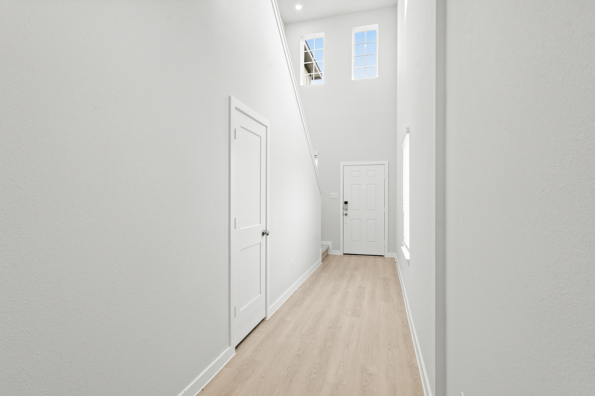 A hallway with white doors.