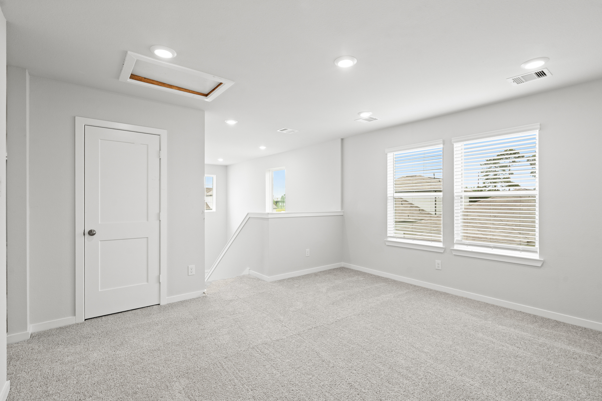 A room with white walls and a white door.