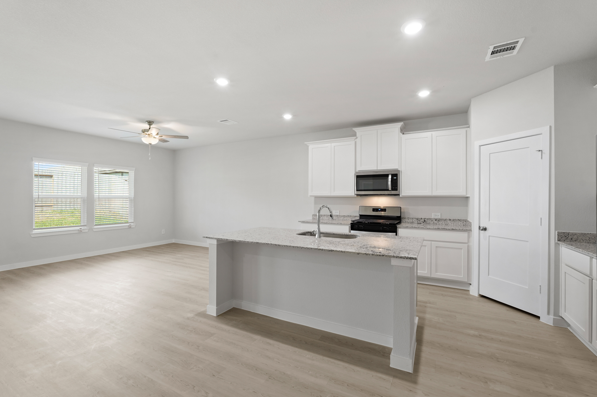 A kitchen with white cabinets.