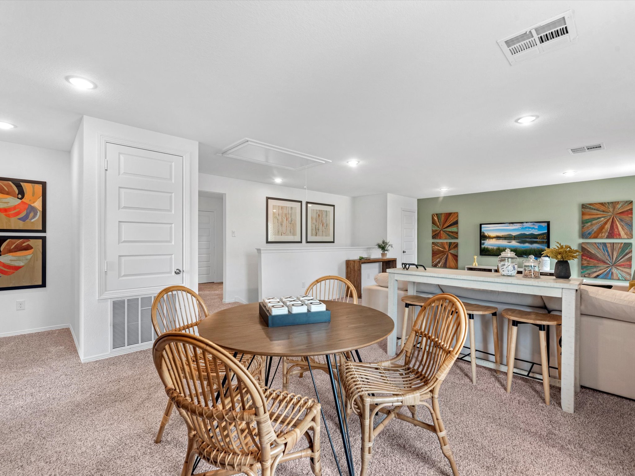 A dining room with a table and chairs.