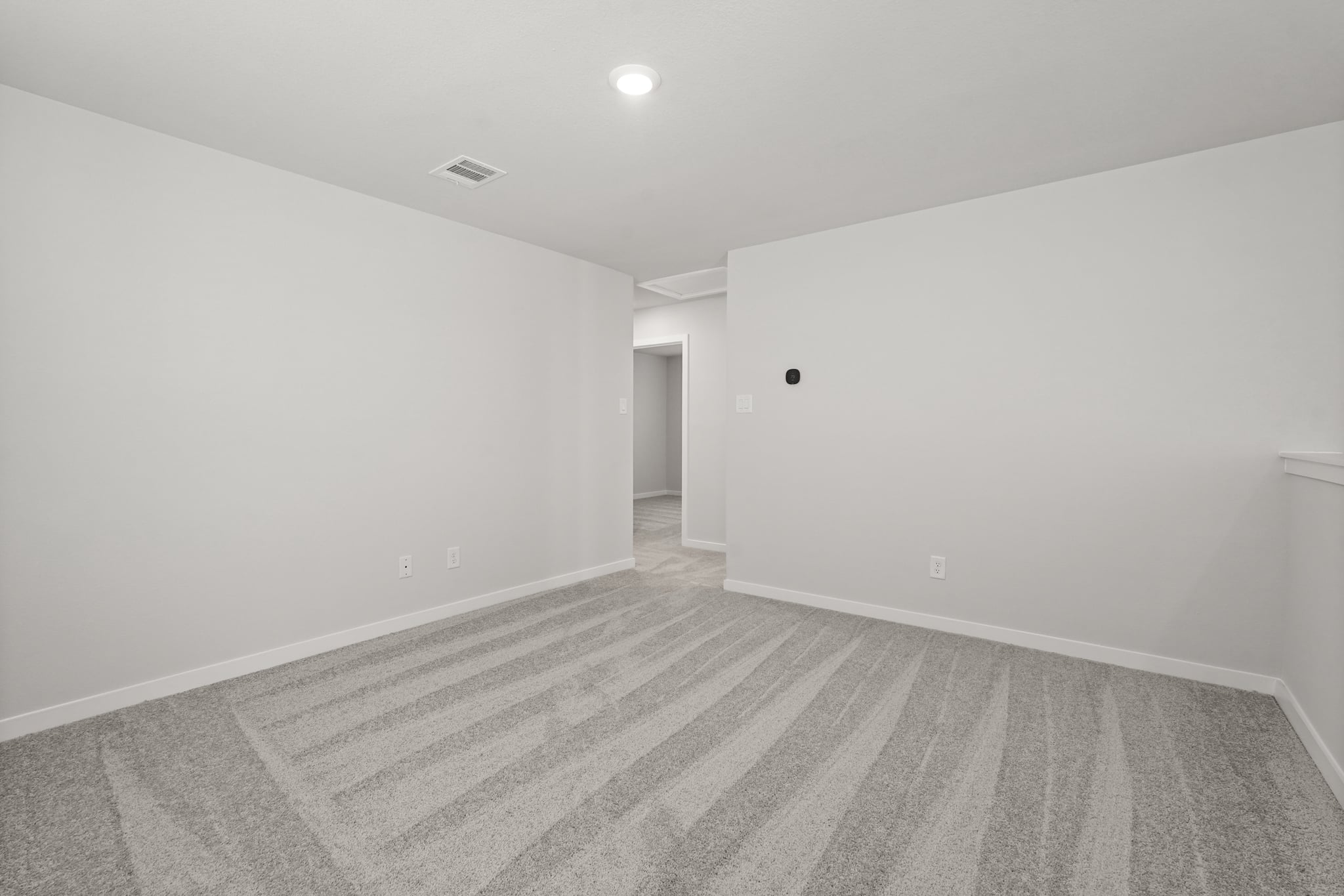 A hallway with a wood floor.