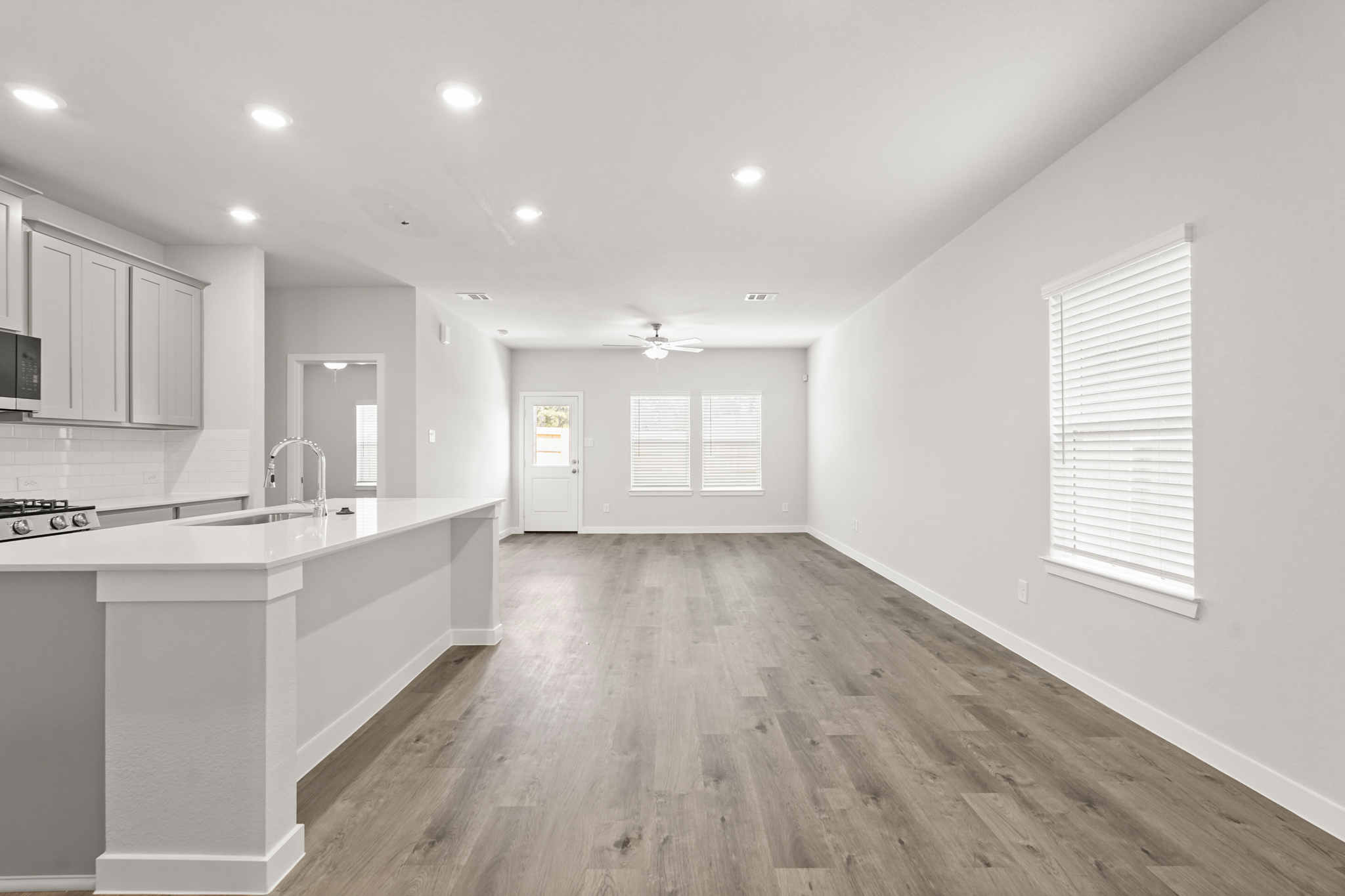 A kitchen with white cabinets.
