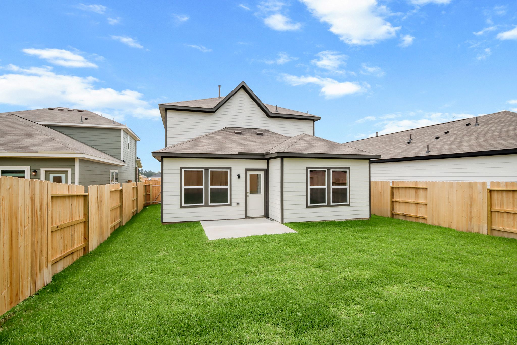 A house with a fence and grass.