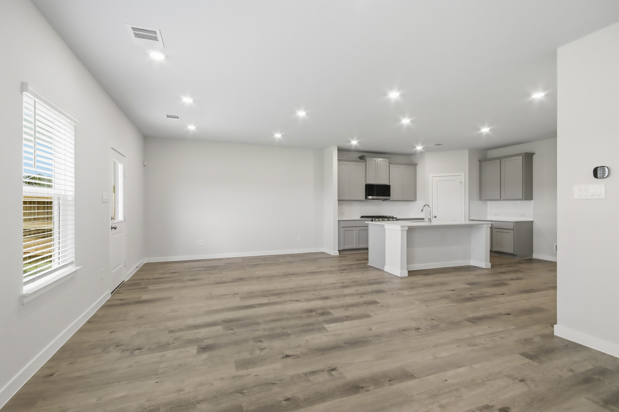 A kitchen with white cabinets.