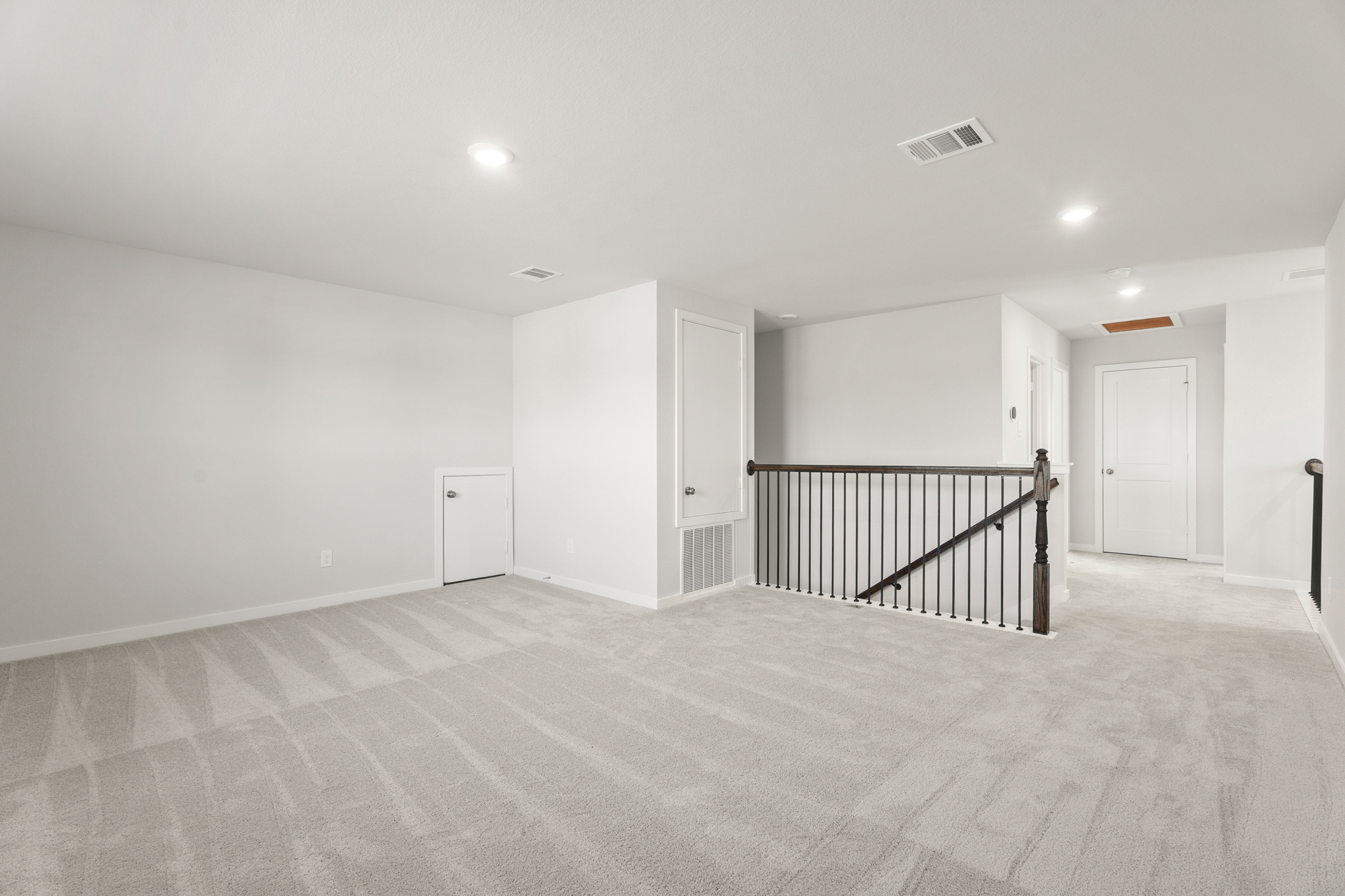 A room with a staircase and white walls.