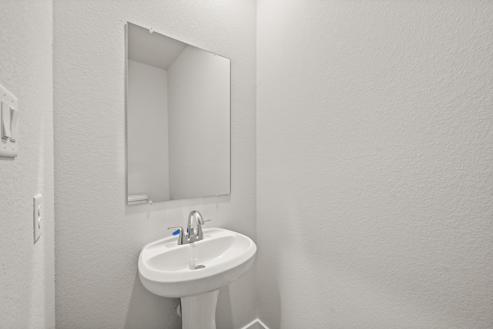A bathroom with a mirror and sink.