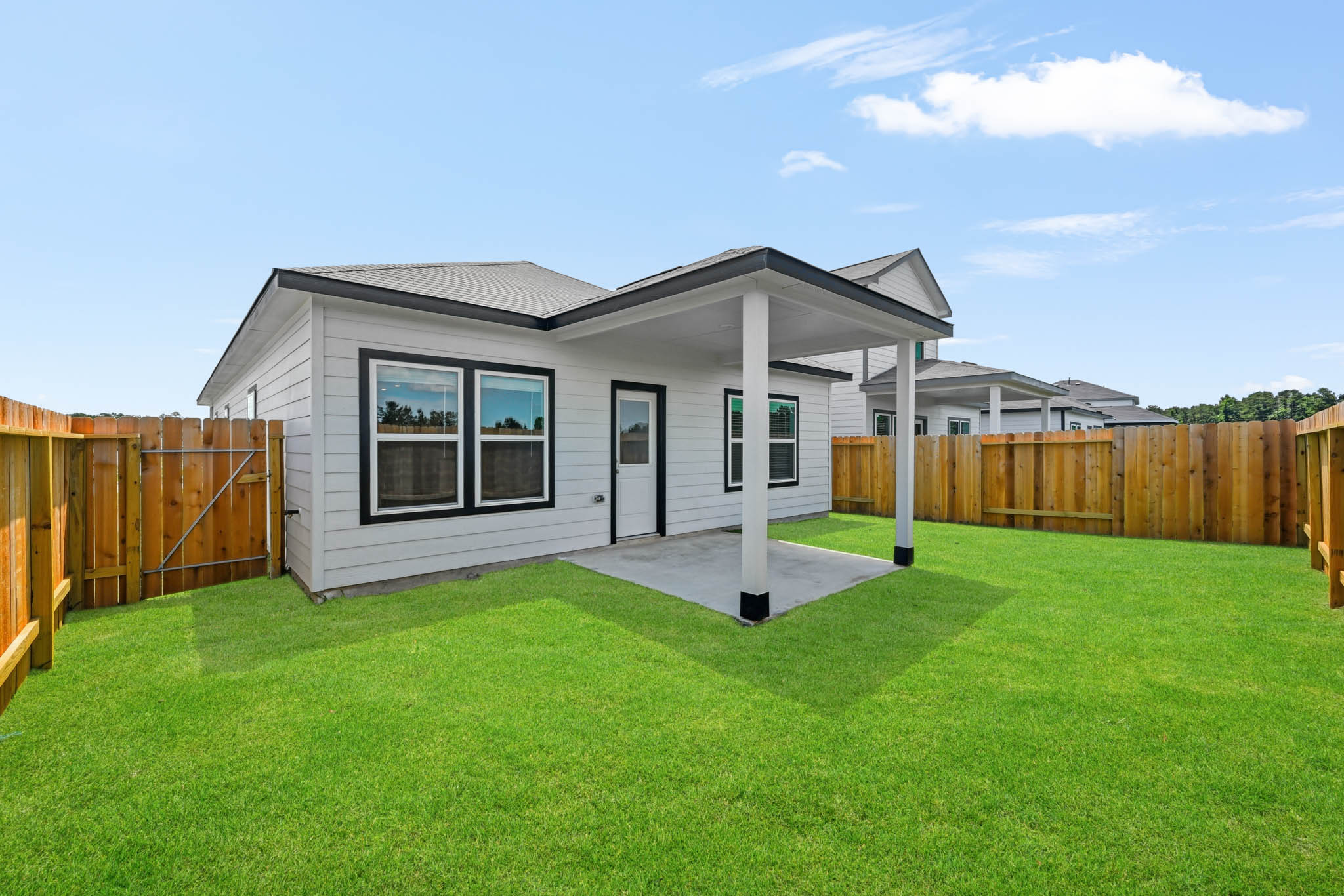 A house with a fence and a yard.