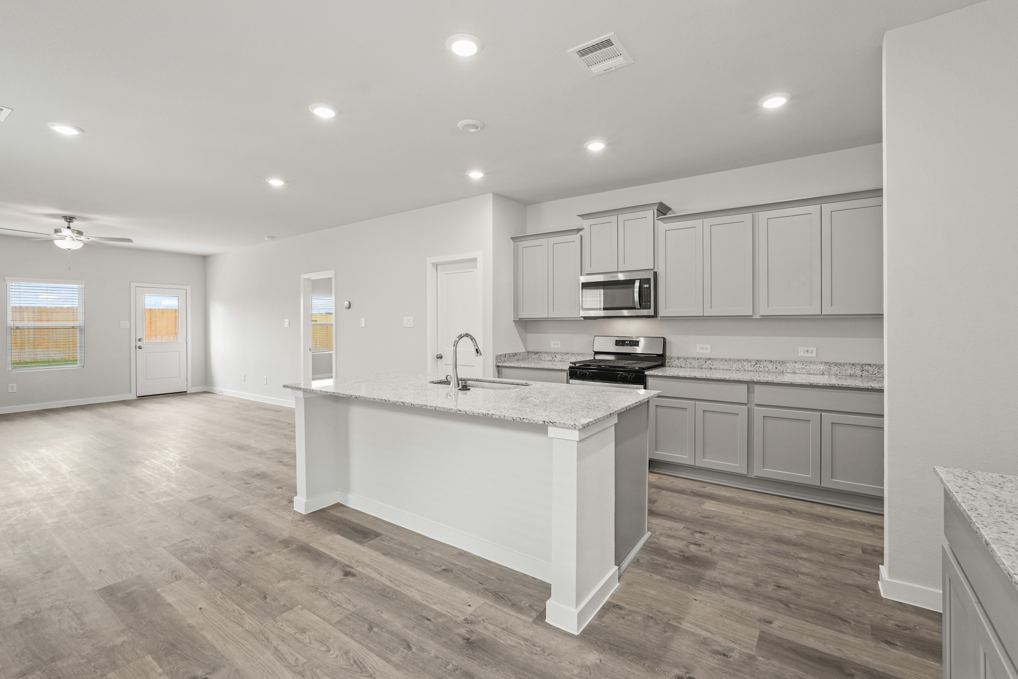 A kitchen with white cabinets.