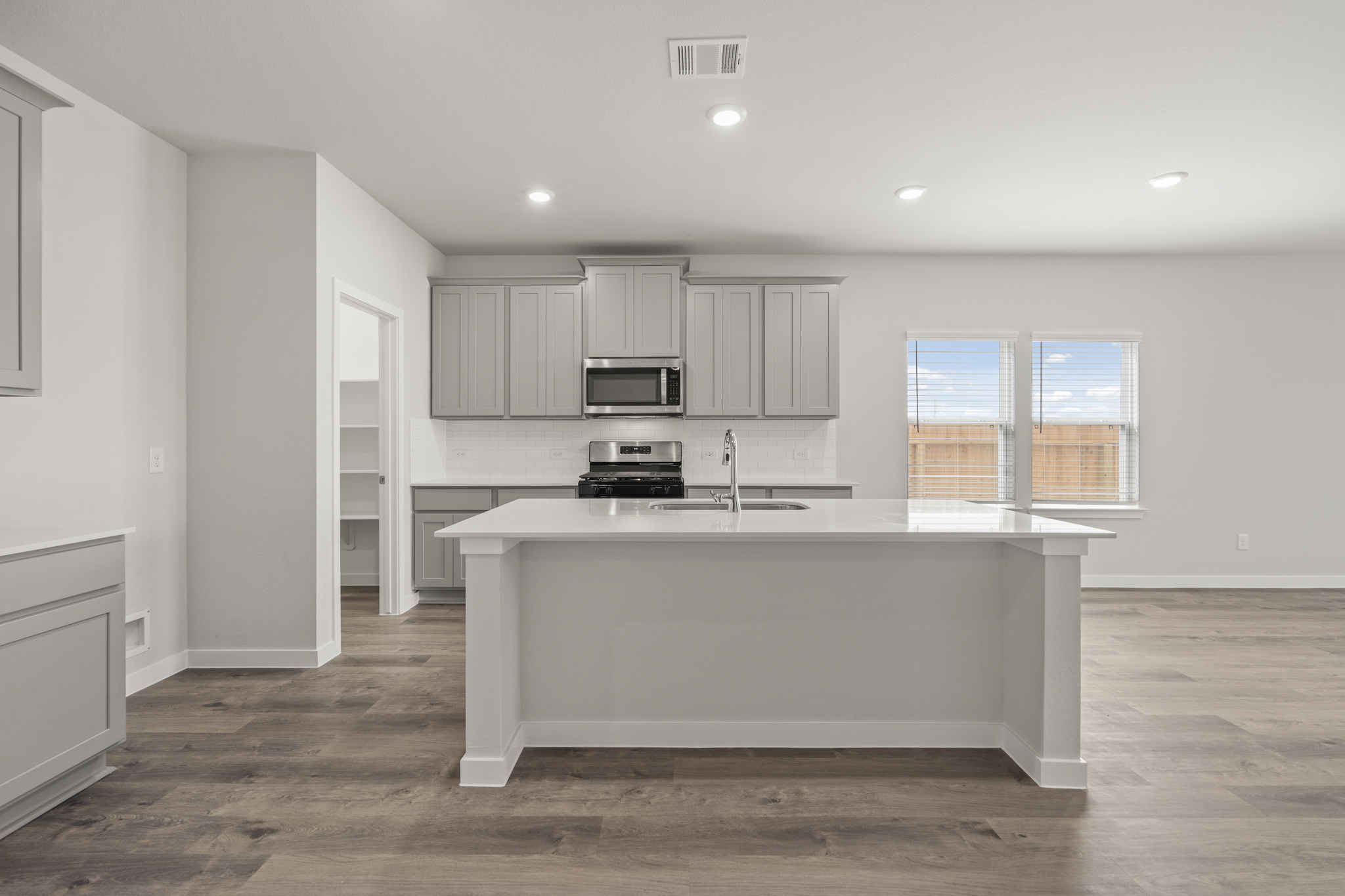 A kitchen with white cabinets.