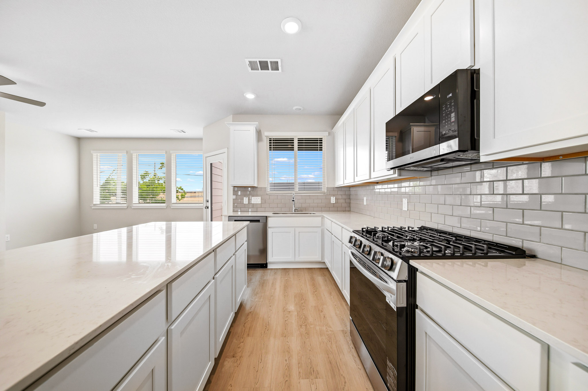 A kitchen with white cabinets.