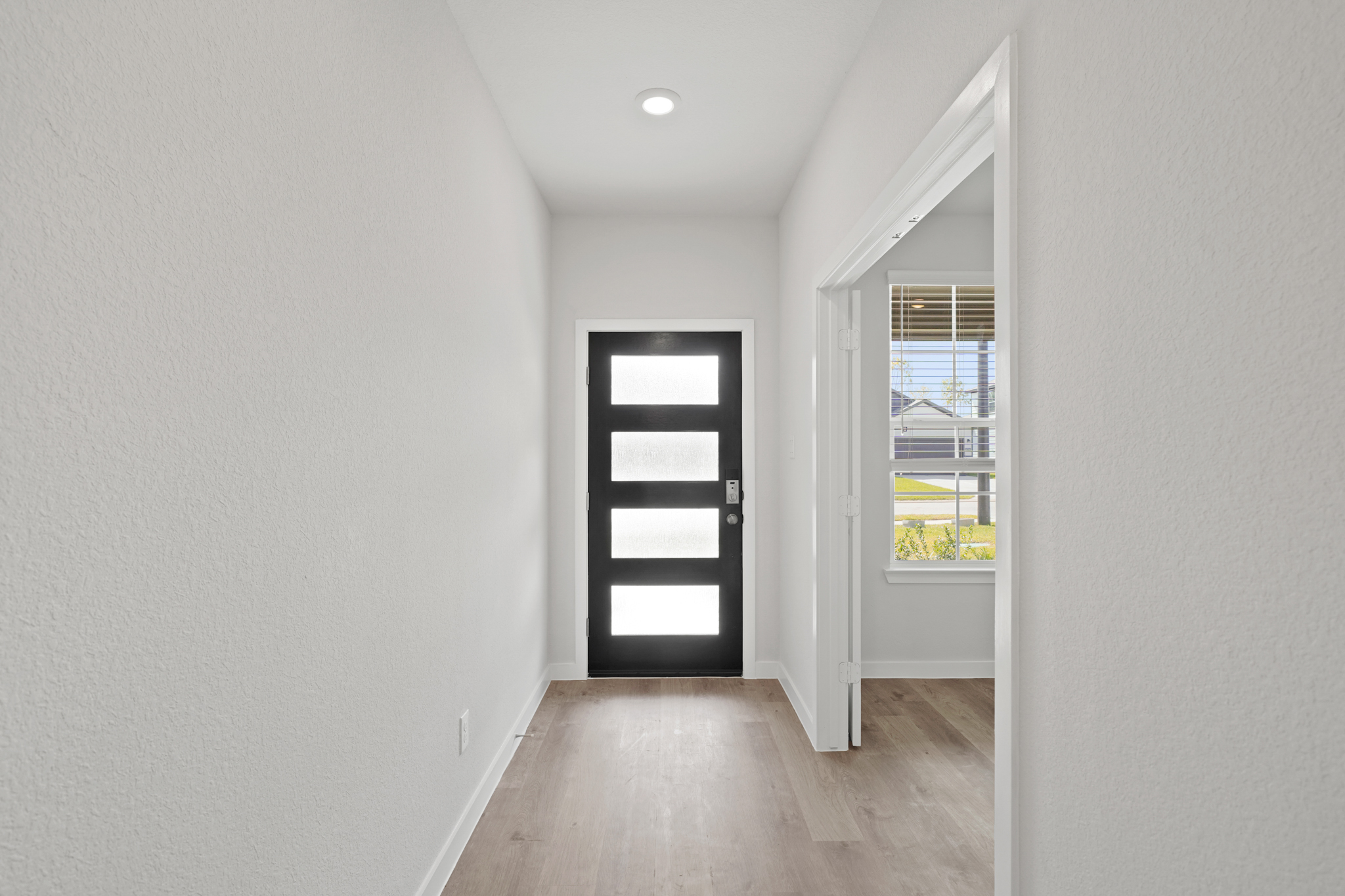 A room with white walls and windows.
