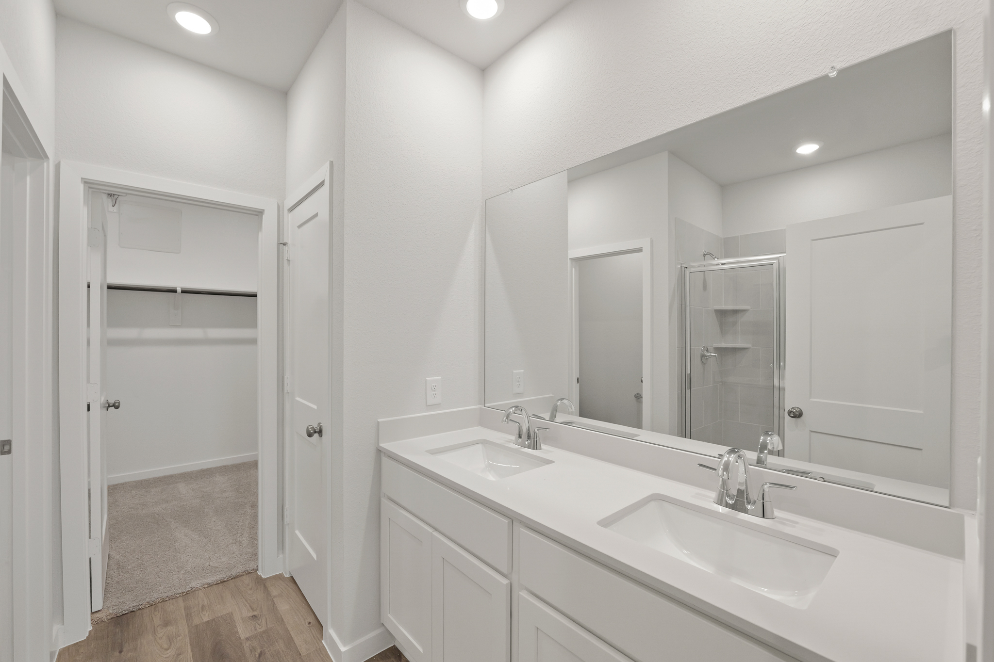 A bathroom with a large mirror.