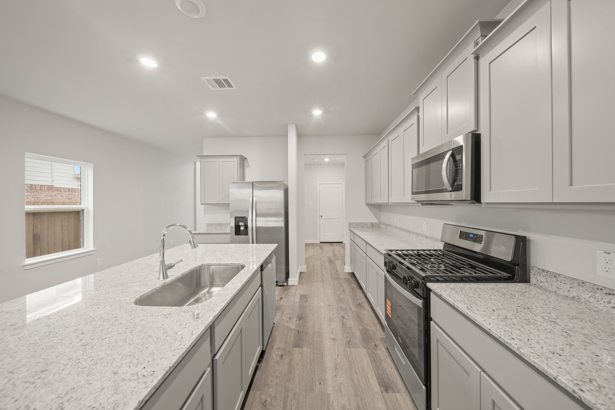 A kitchen with white cabinets.