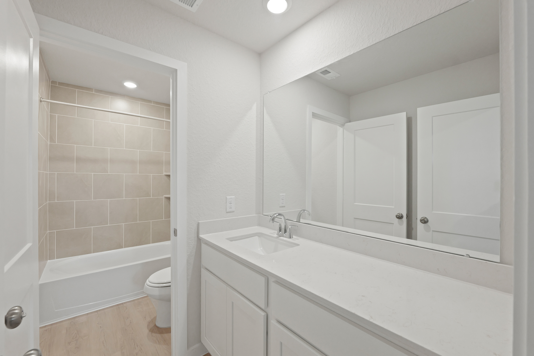 A bathroom with a tub sink and toilet.