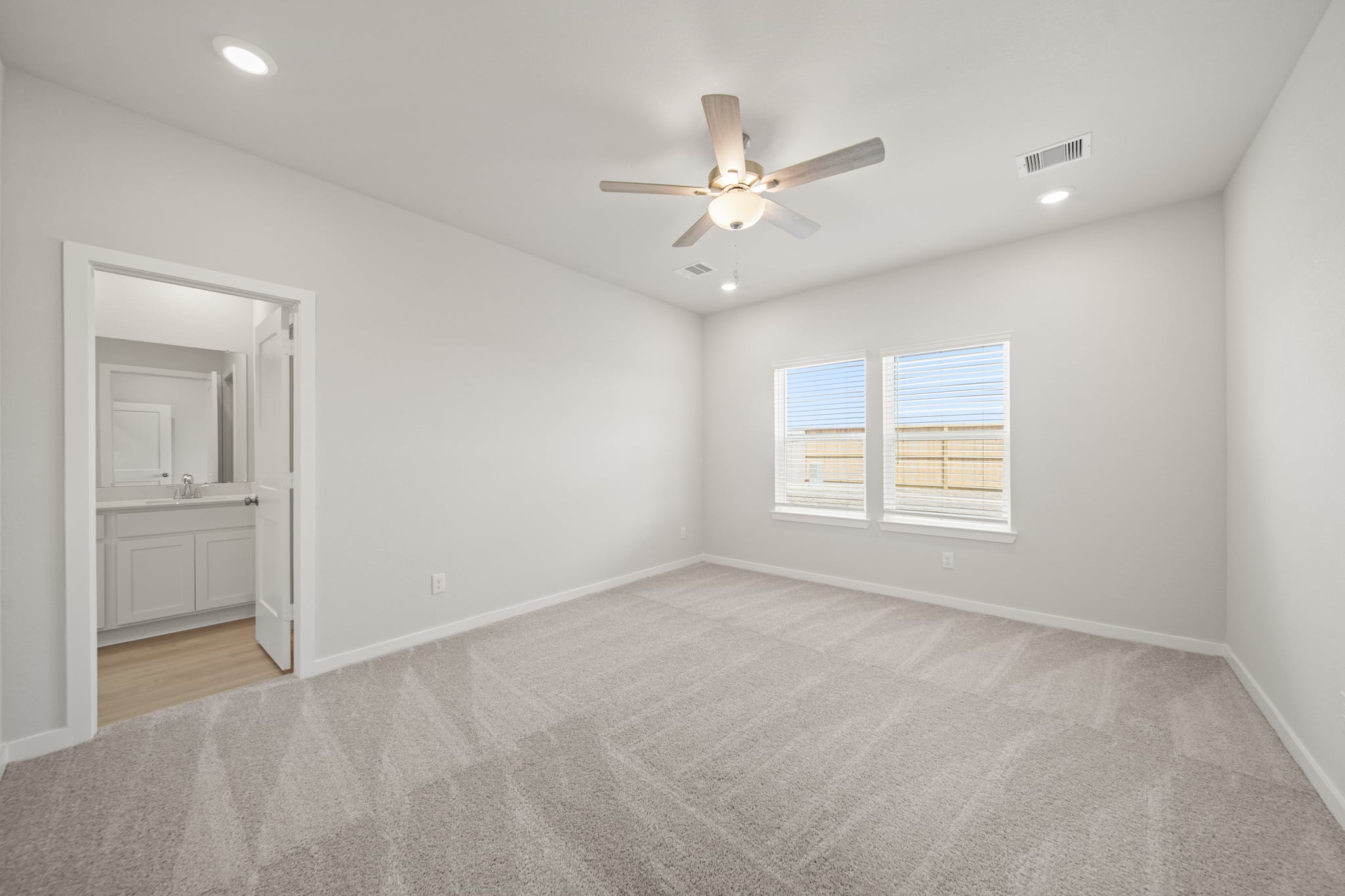 A room with a ceiling fan and a window.