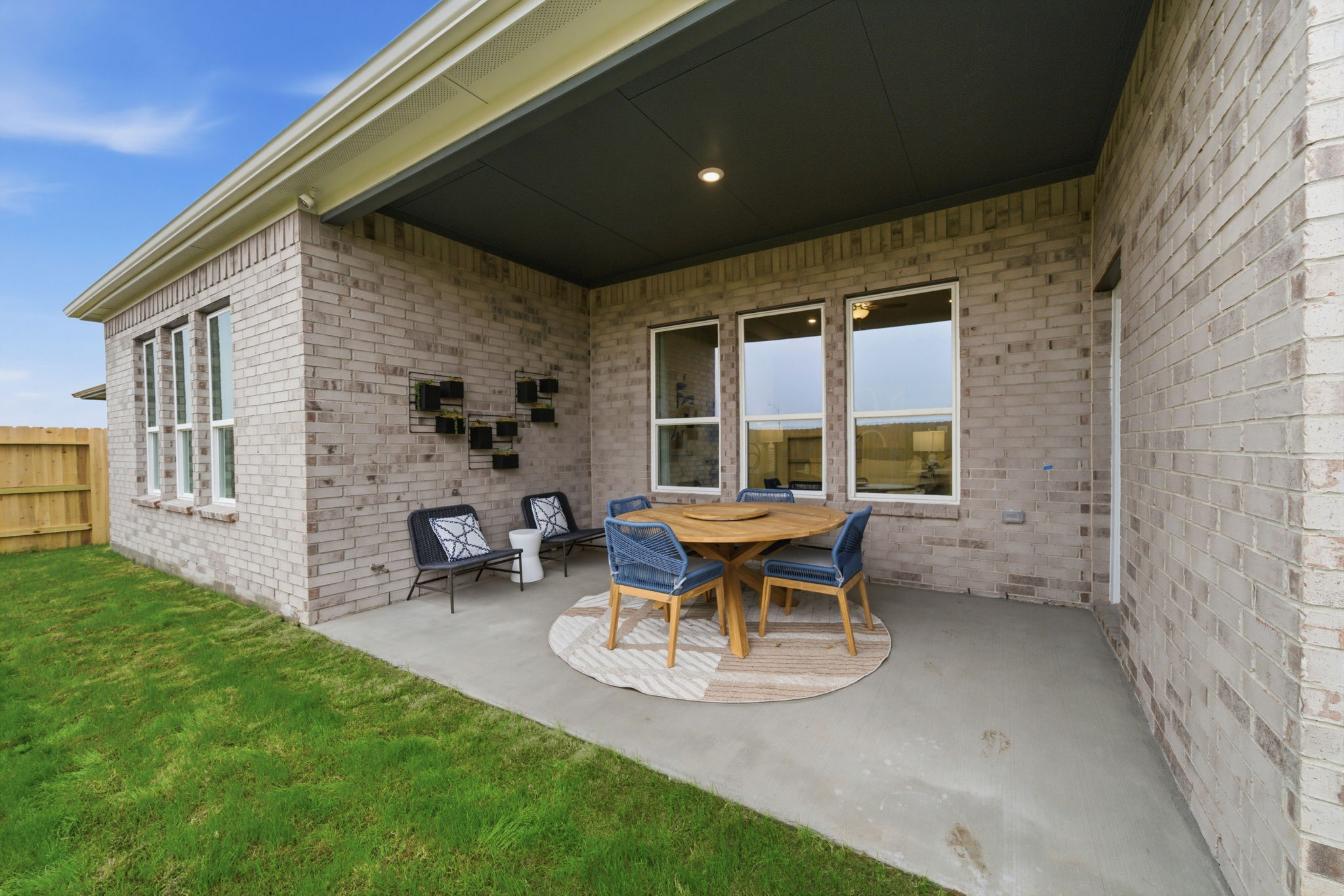 A backyard with a table and chairs.