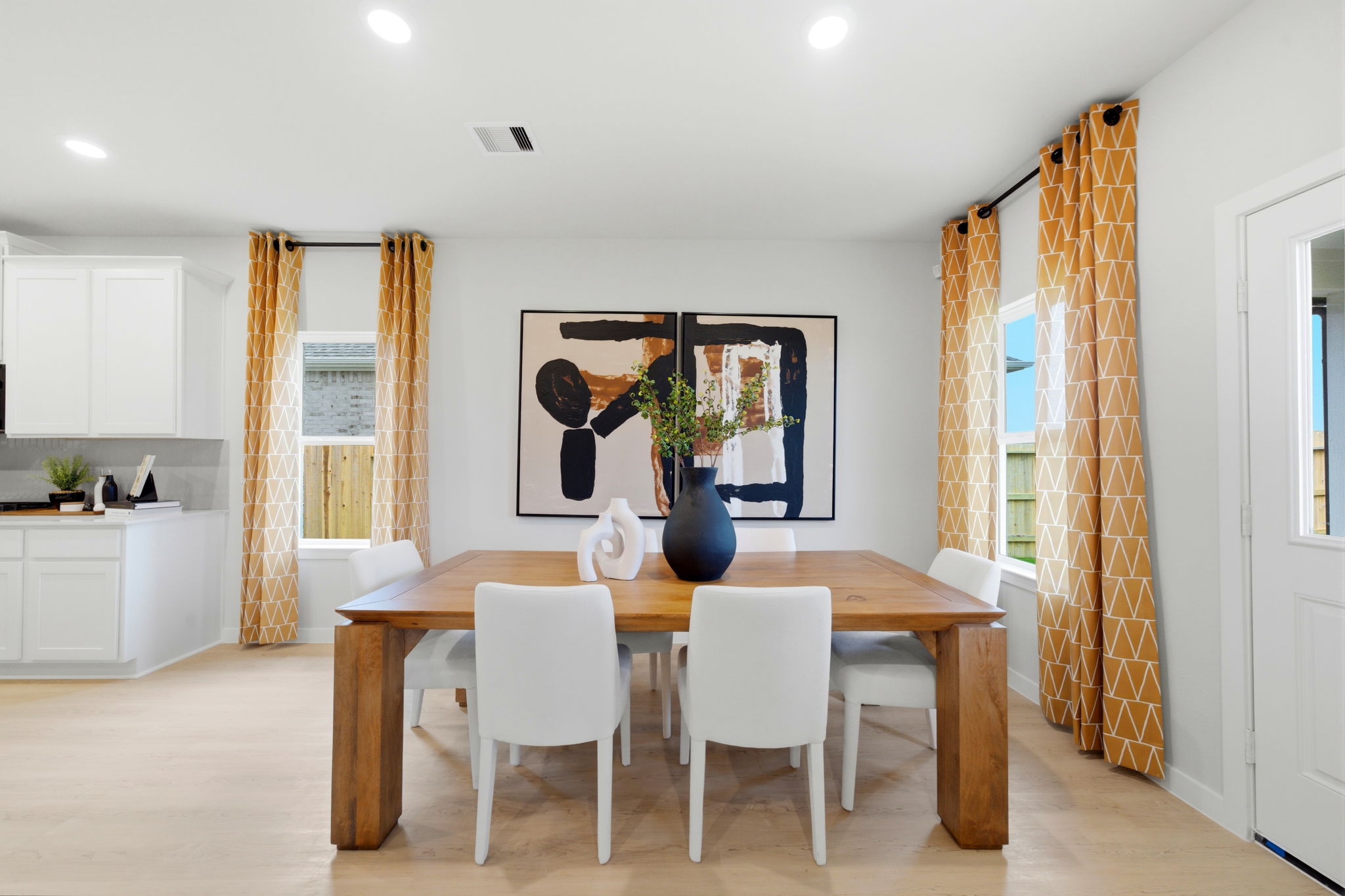 A dining room with a table and chairs.