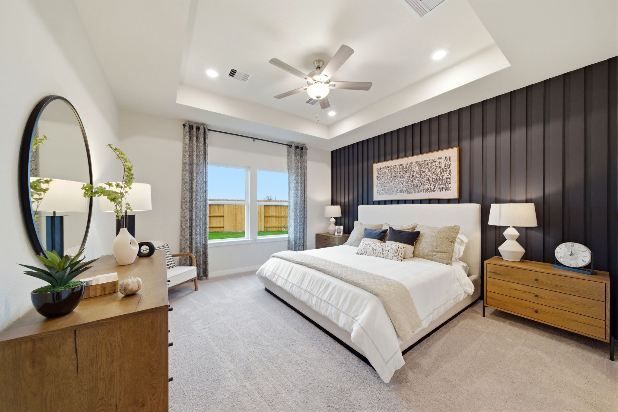 A bedroom with a large mirror.