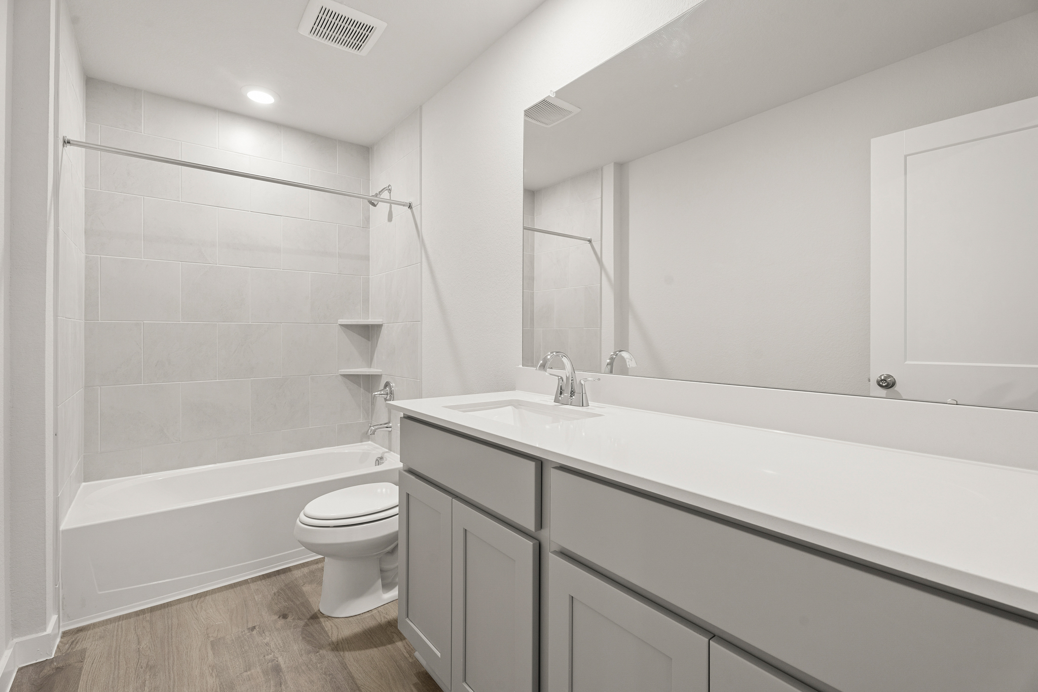 A bathroom with a tub toilet and sink.