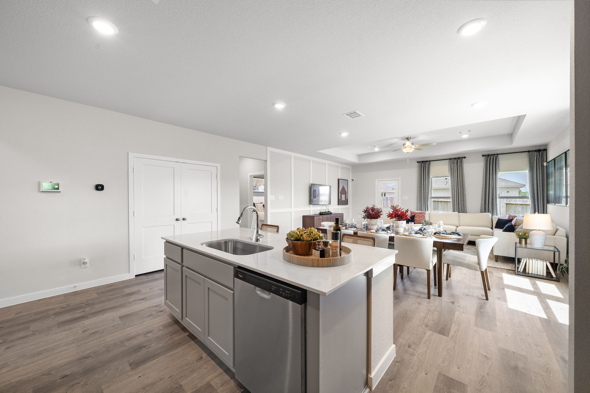 A kitchen with white cabinets.
