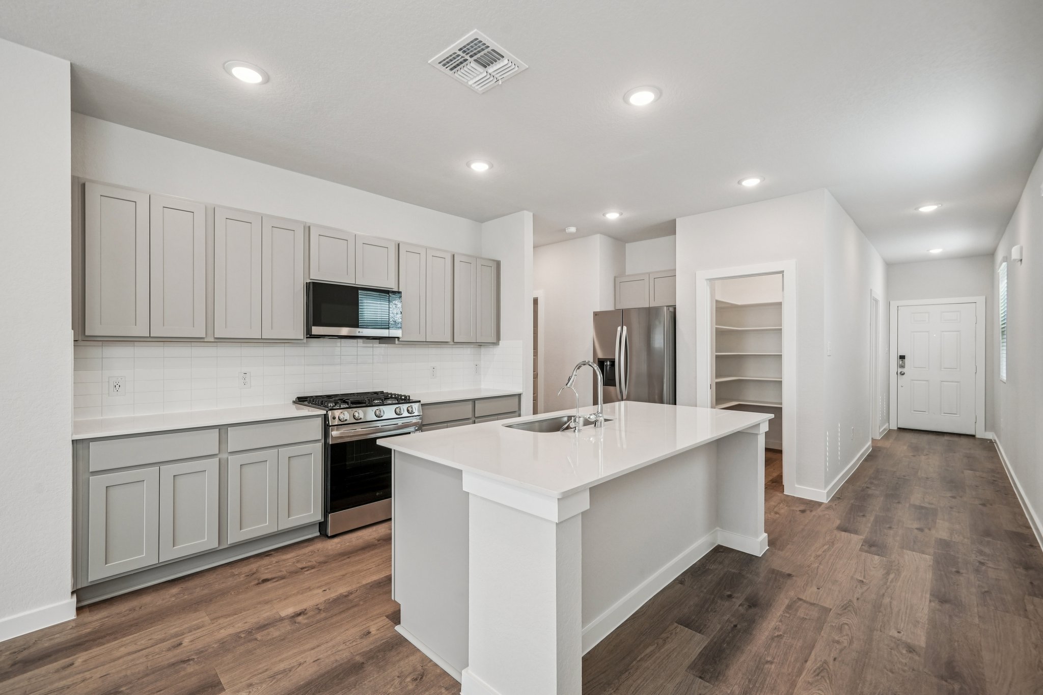 A kitchen with white cabinets.