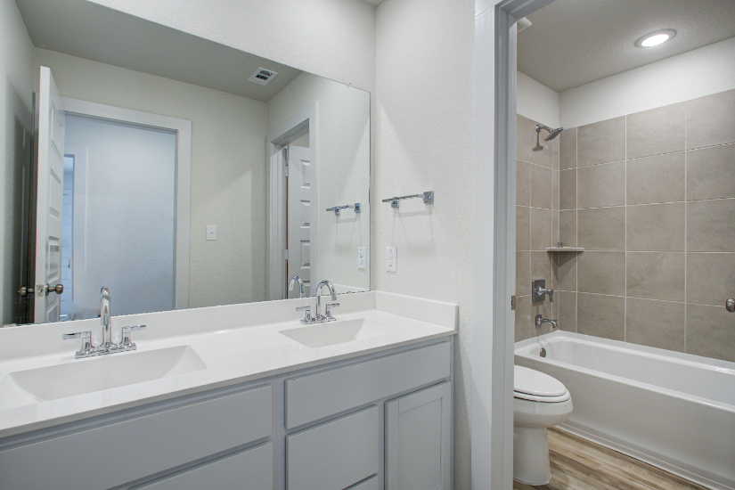 A bathroom with a tub sink and toilet.