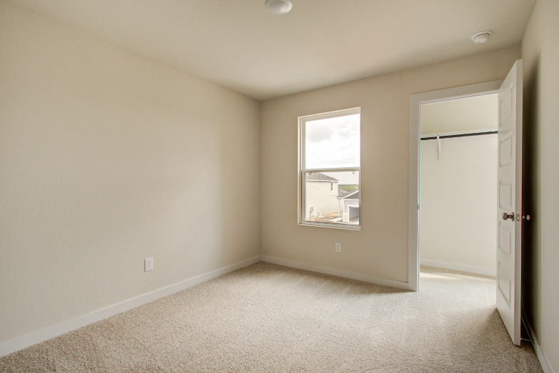 A room with a window and a door.