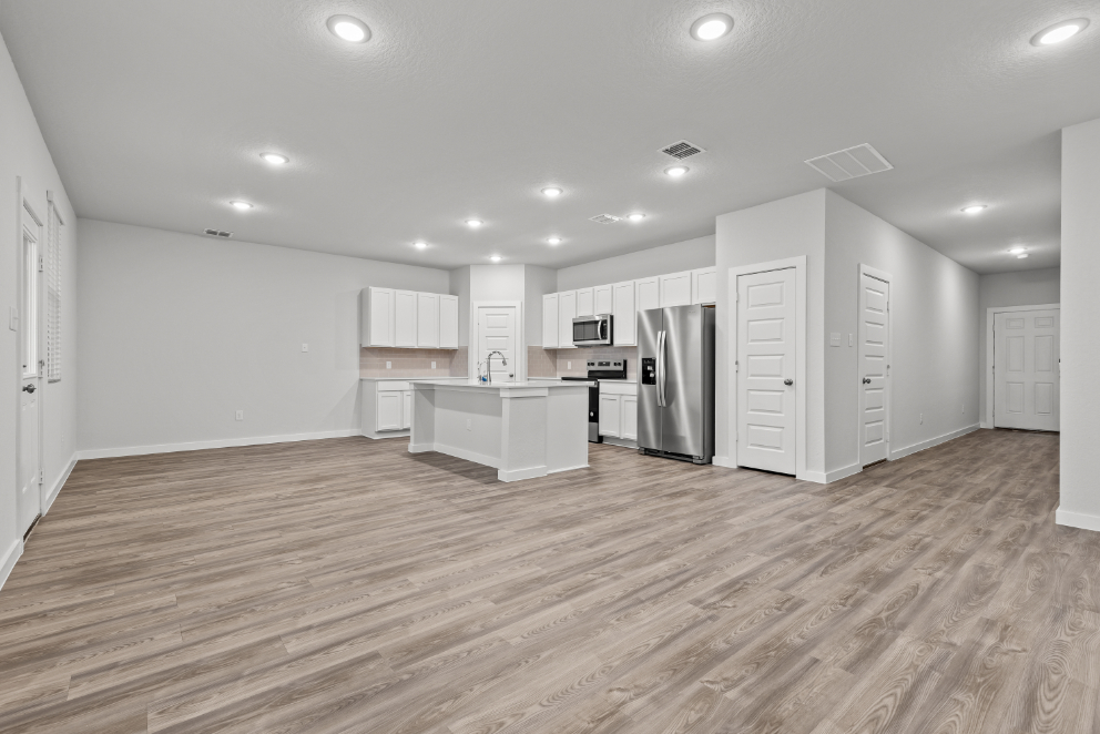 A kitchen with white cabinets.