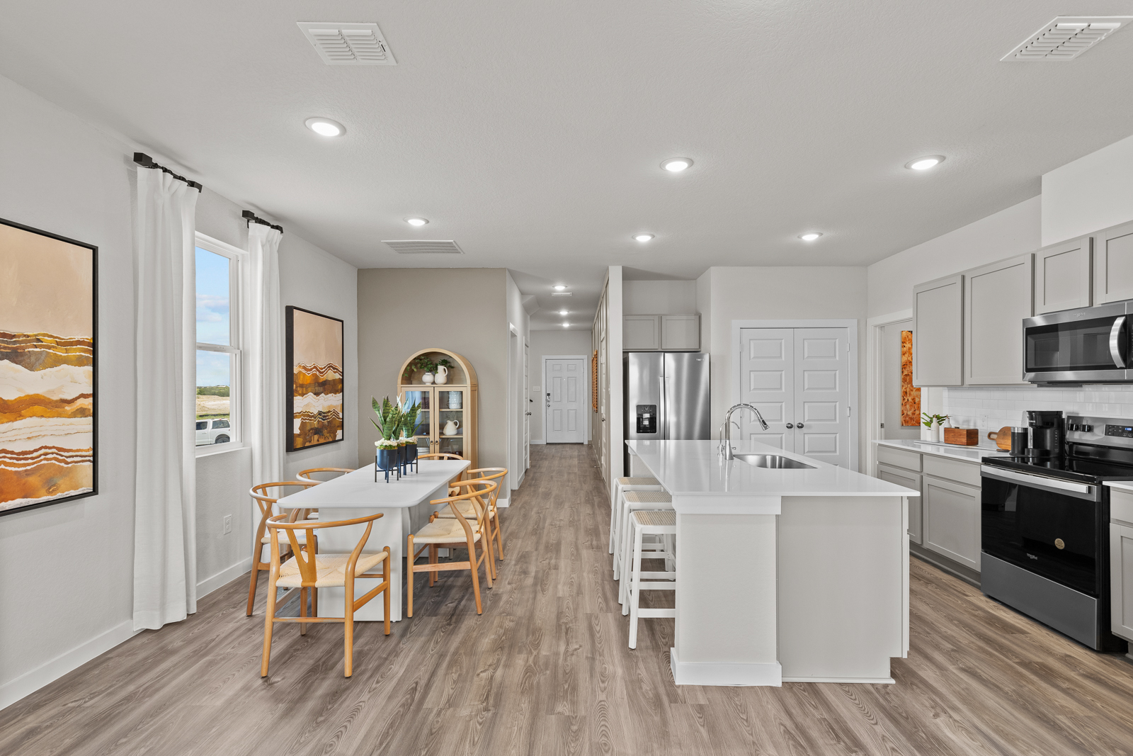 A kitchen with white cabinets.