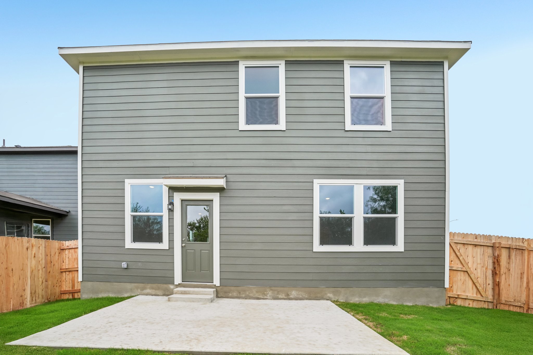 A grey house with a white door.