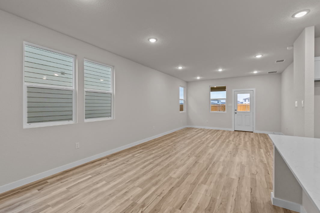 A room with white walls and a wood floor.